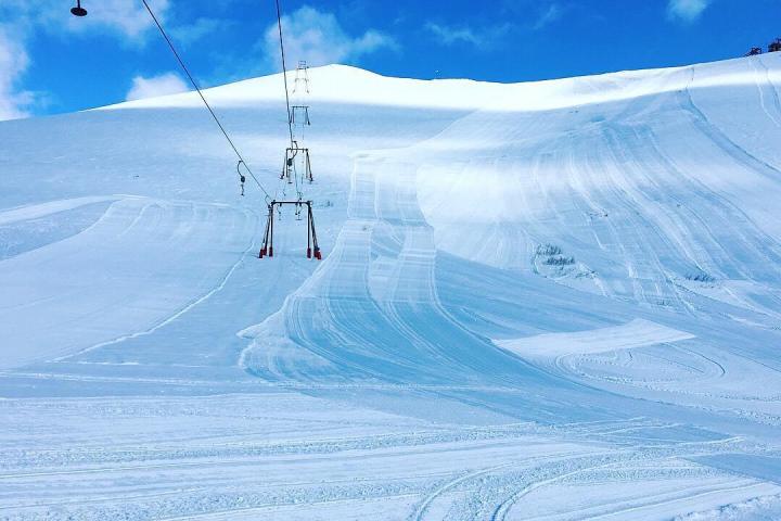 a man flying through the air on a snow covered slope