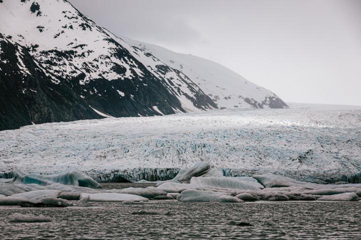 a group of ice water and a mountain in the background