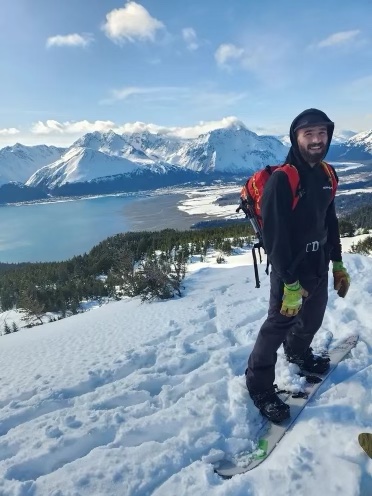 a person standing on top of a snow covered mountain